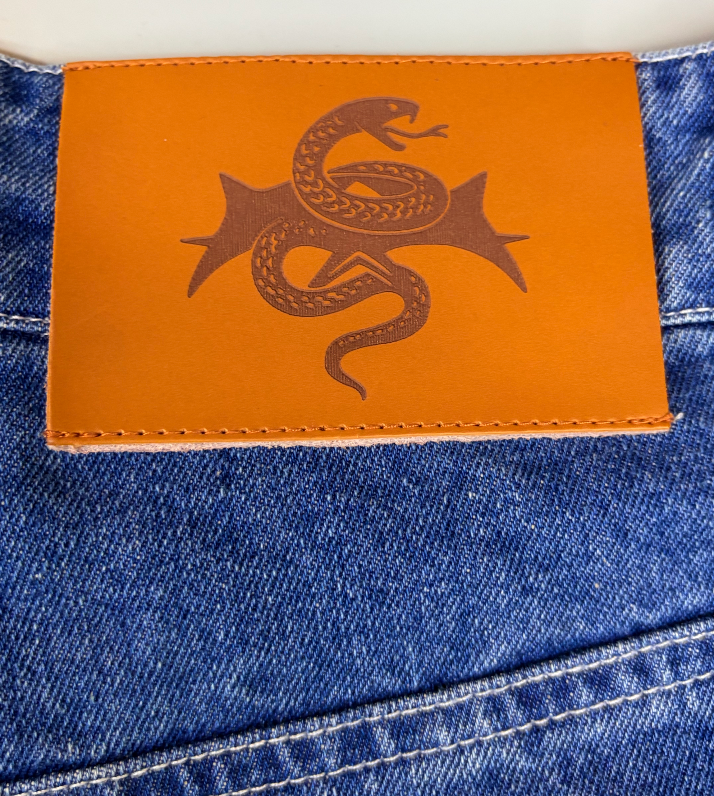 Denim jeans leather patch branding detail