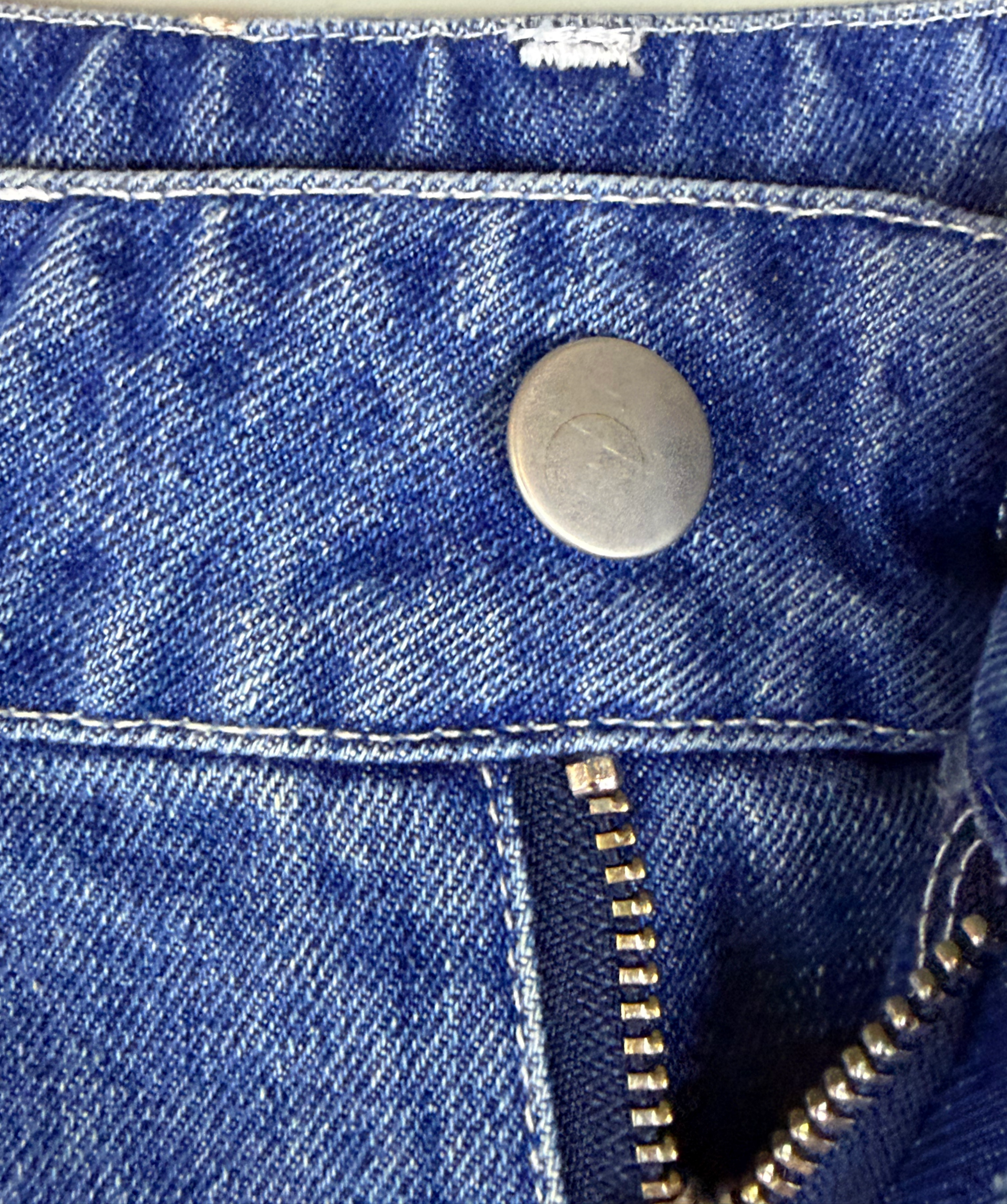 Denim jeans metal button and rivet detail