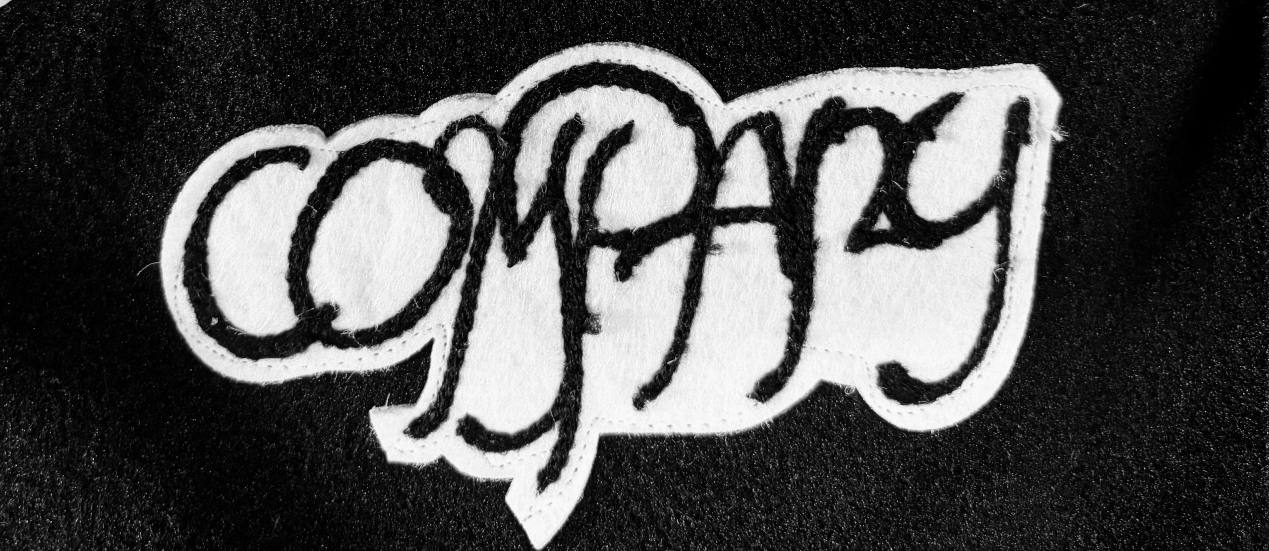Applique embroidery detail on custom varsity jacket
