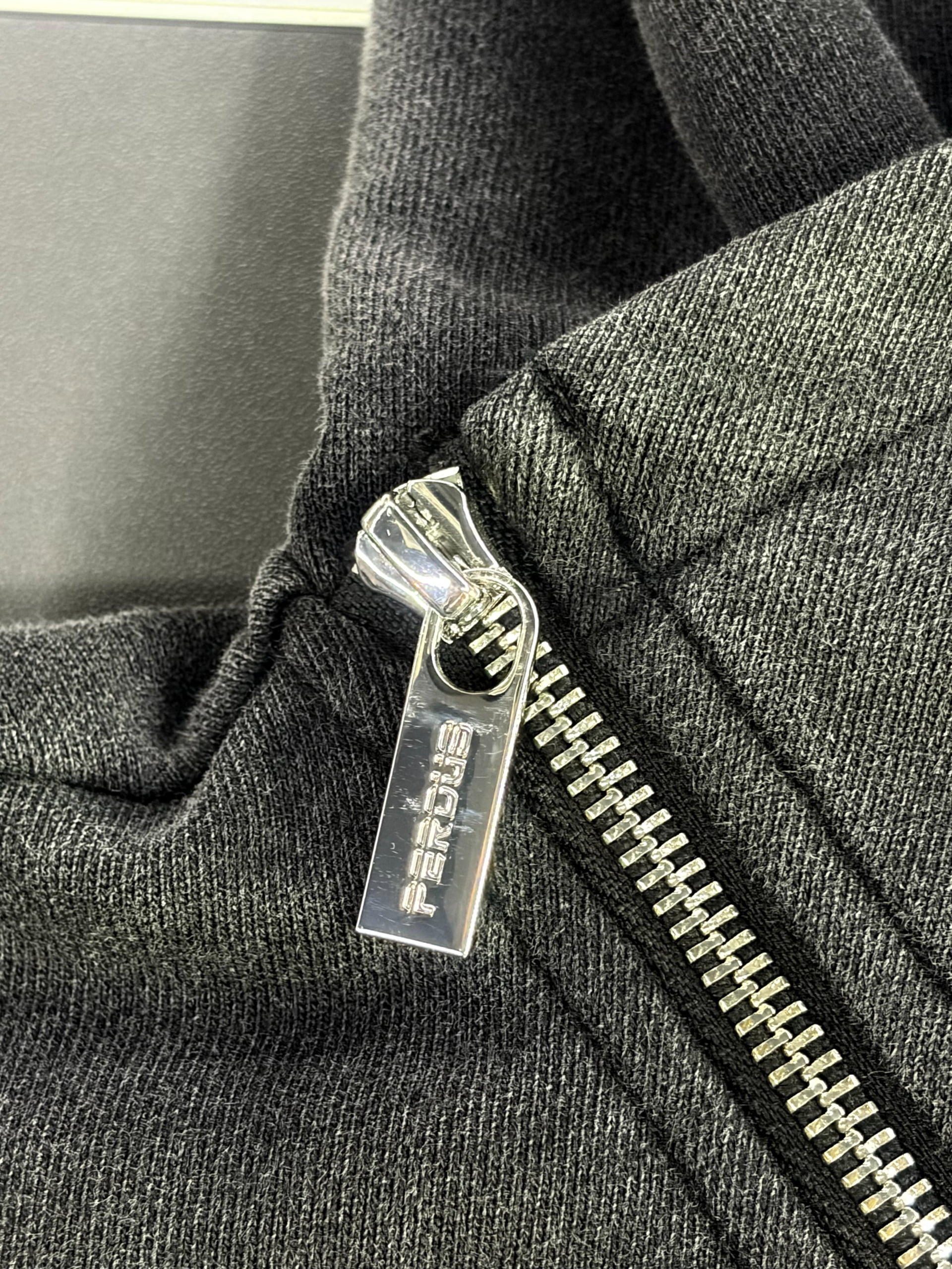 Two-way zipper and metal puller detail on a custom zip-up hoodie
