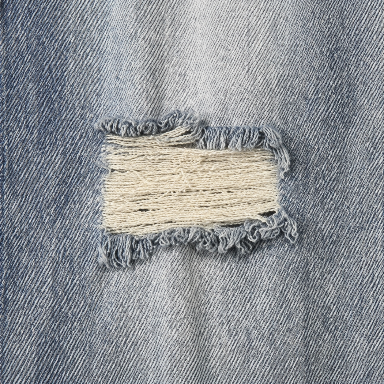 Distressed denim jeans detail
