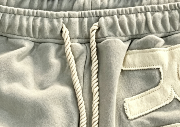 Eyelets and cord ends used on custom garments